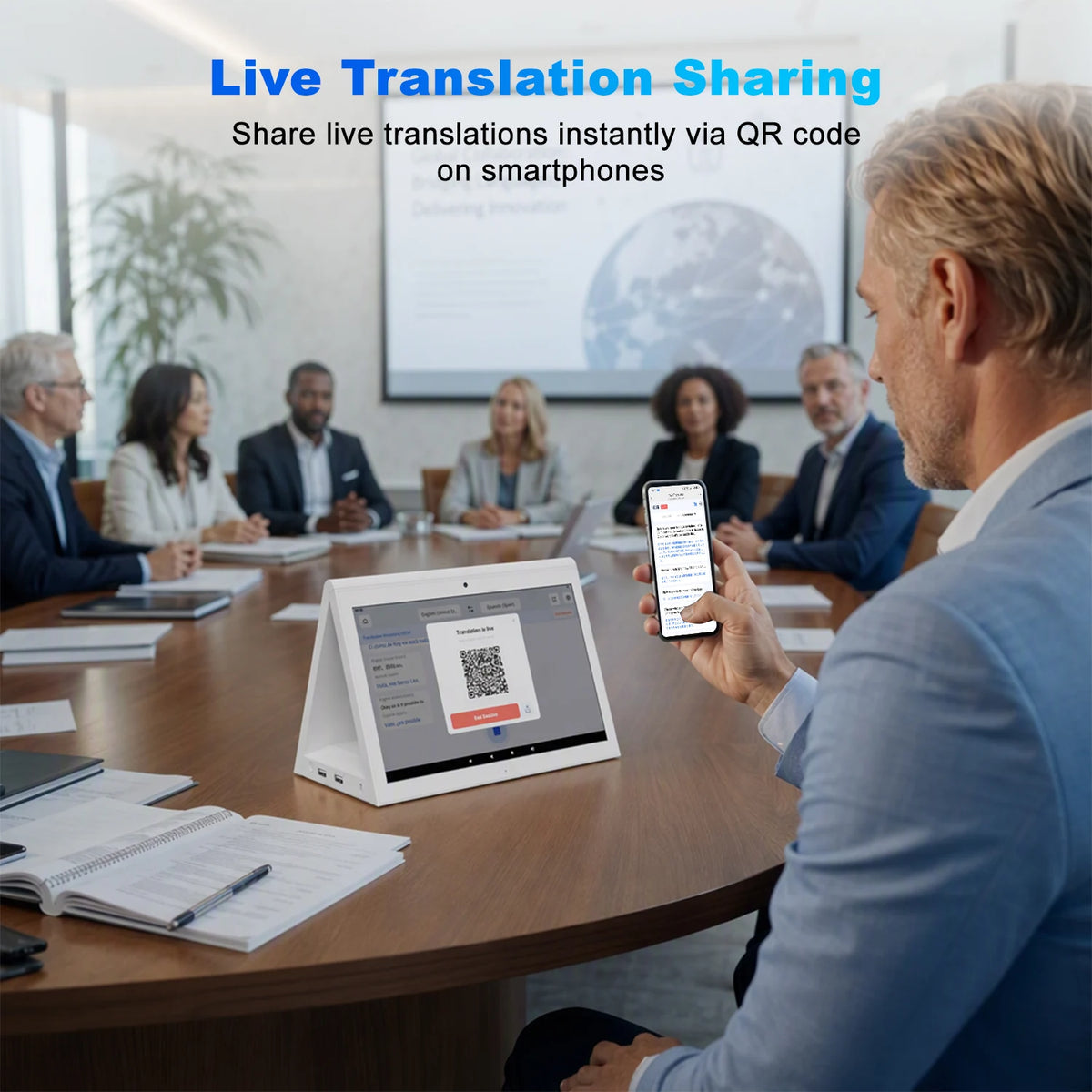 A man in a blue suit sits at a conference table holding a smartphone that displays a QR code, with a tablet on the table showing a translation interface. Other meeting participants are seated around him, and a presentation screen in the background shows a globe.